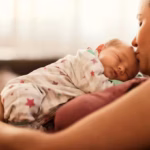 mother holding newborn baby after giving birth in a hospital in the United States